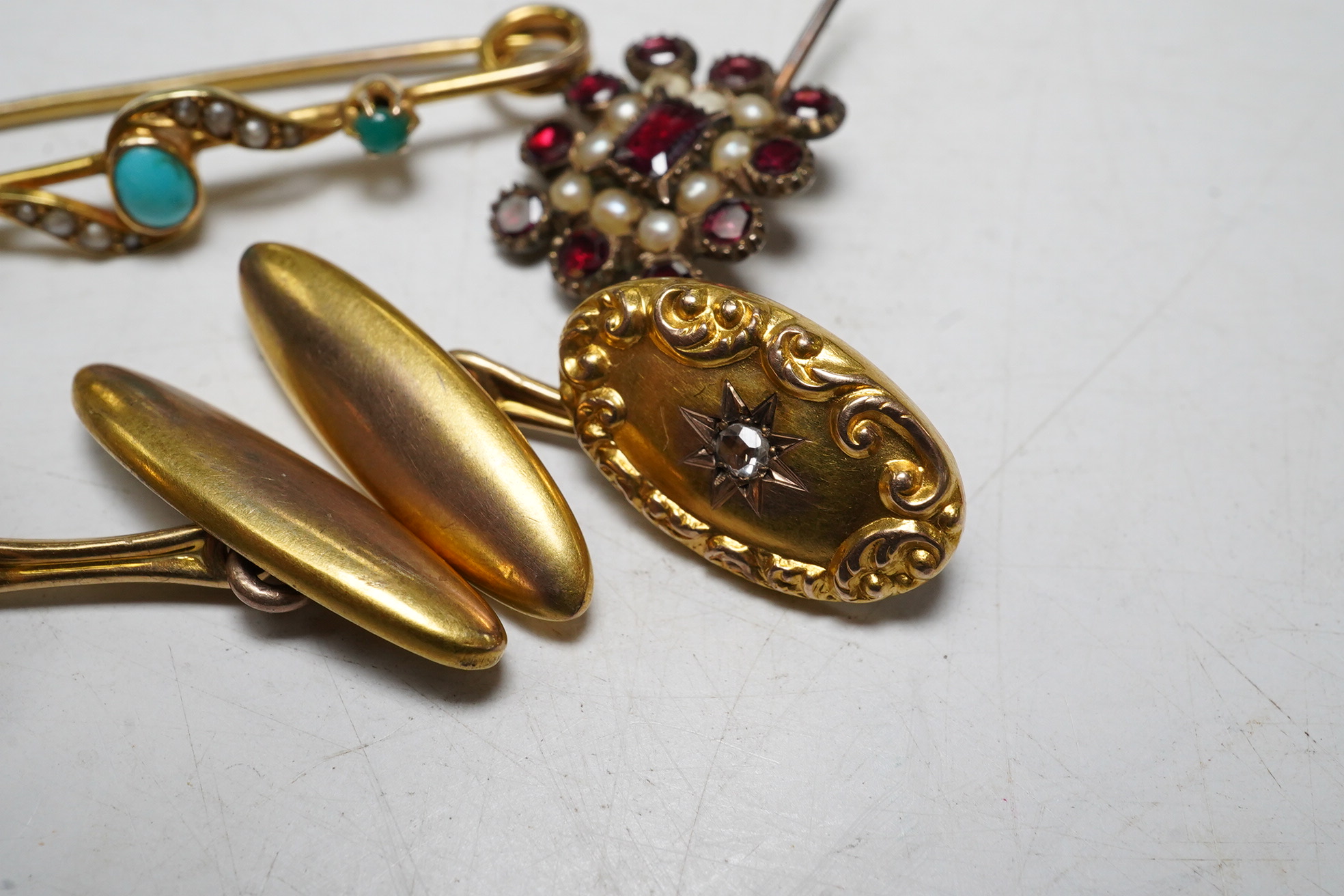 A 15ct gold split pearl and turquoise bar brooch, gross 1.9 grams, a pair unmarked yellow metal cufflinks, each set with an old cut diamond, gross 4.3 grams and an early Victorian garnet and pearl set mourning brooch. Co